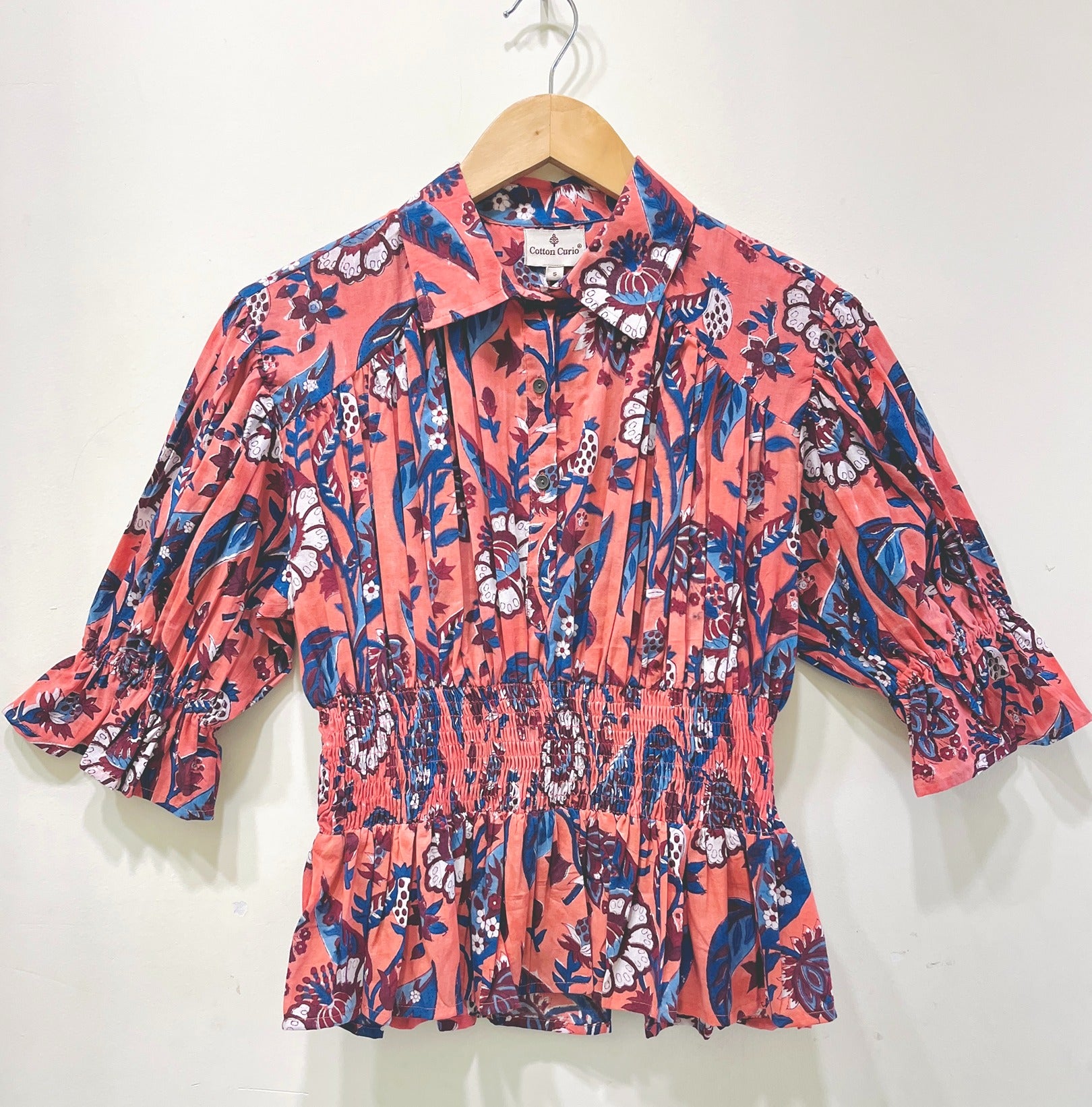 Coral Garden Smocked Peplum Top